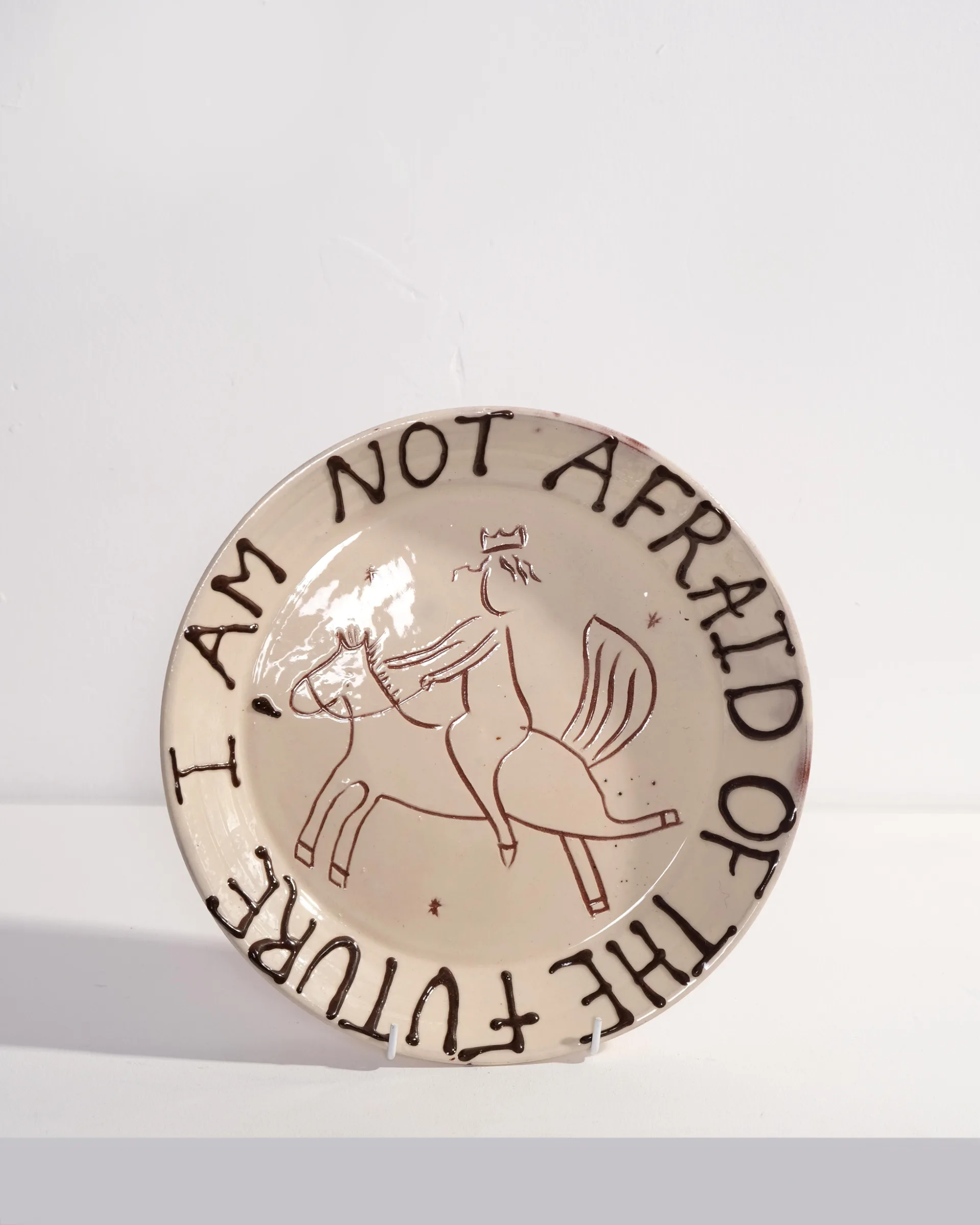 Large Plate with 'I am not afraid of the future' and Person Riding Horse Design